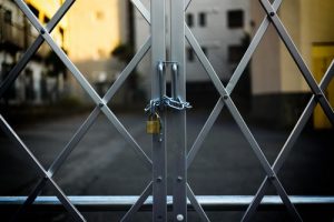 gray steel gate closed with padlock