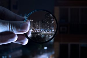 A person holding a magnifying glass