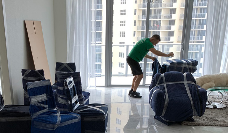 A mover preparing office items for transport.