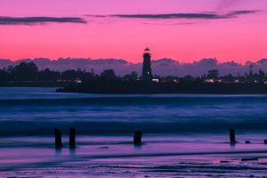 Purple sunset and a lighthouse you can enjoy in after moving to California in 2020