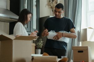 couple packing items for a move 
