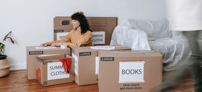 Woman packing for moving from Miami to San Francisco