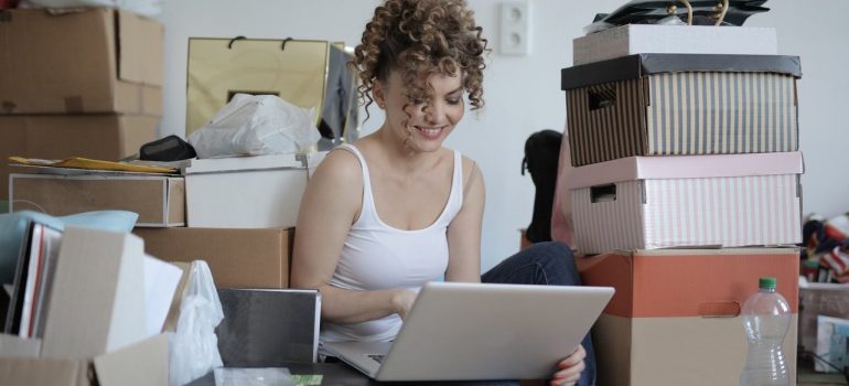 A woman, a laptop and boxes