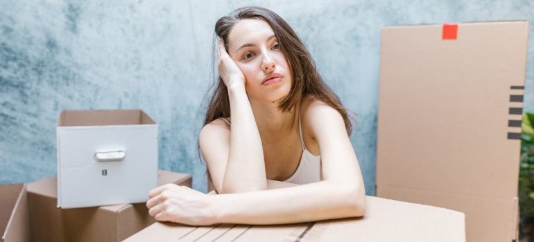 Woman resting on a cardboard box