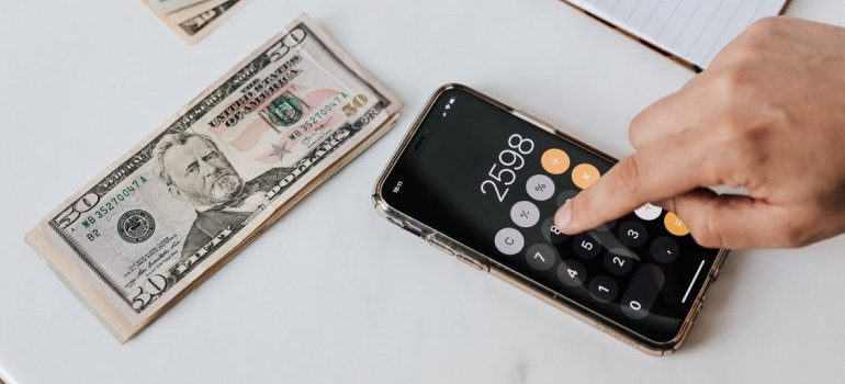 Calculator on the phone near dollars