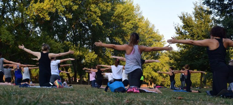 Women are performing yoga outside