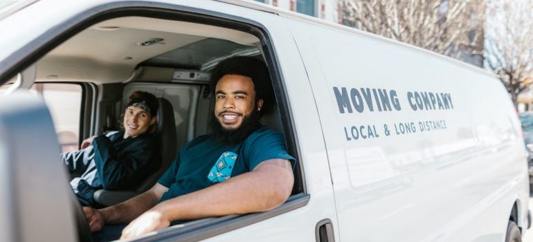 Two movers in a moving van.