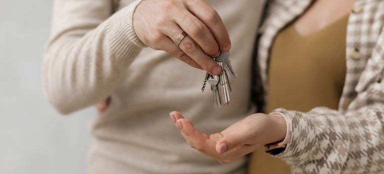 man holding keys after buying a house in Mimi remotely