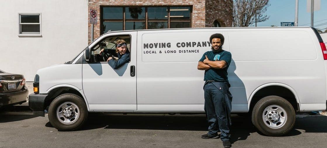 Two moving workers with a white van