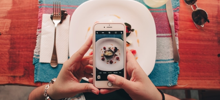 a person taking picture of food