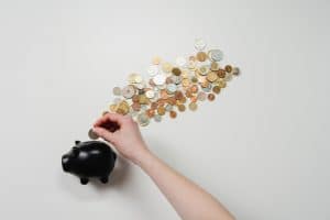 coins and a black piggy bank