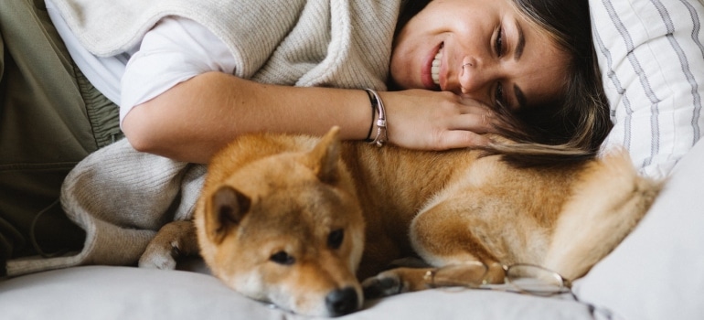 A woman cuddling with her dog