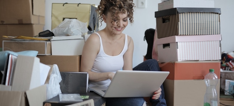 A woman looking up the things to know about hiring movers in Florida